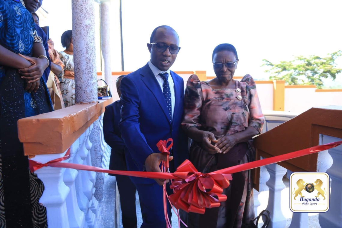 Hon. Joseph Kawuki inaugurates the new office by cutting a ribbon